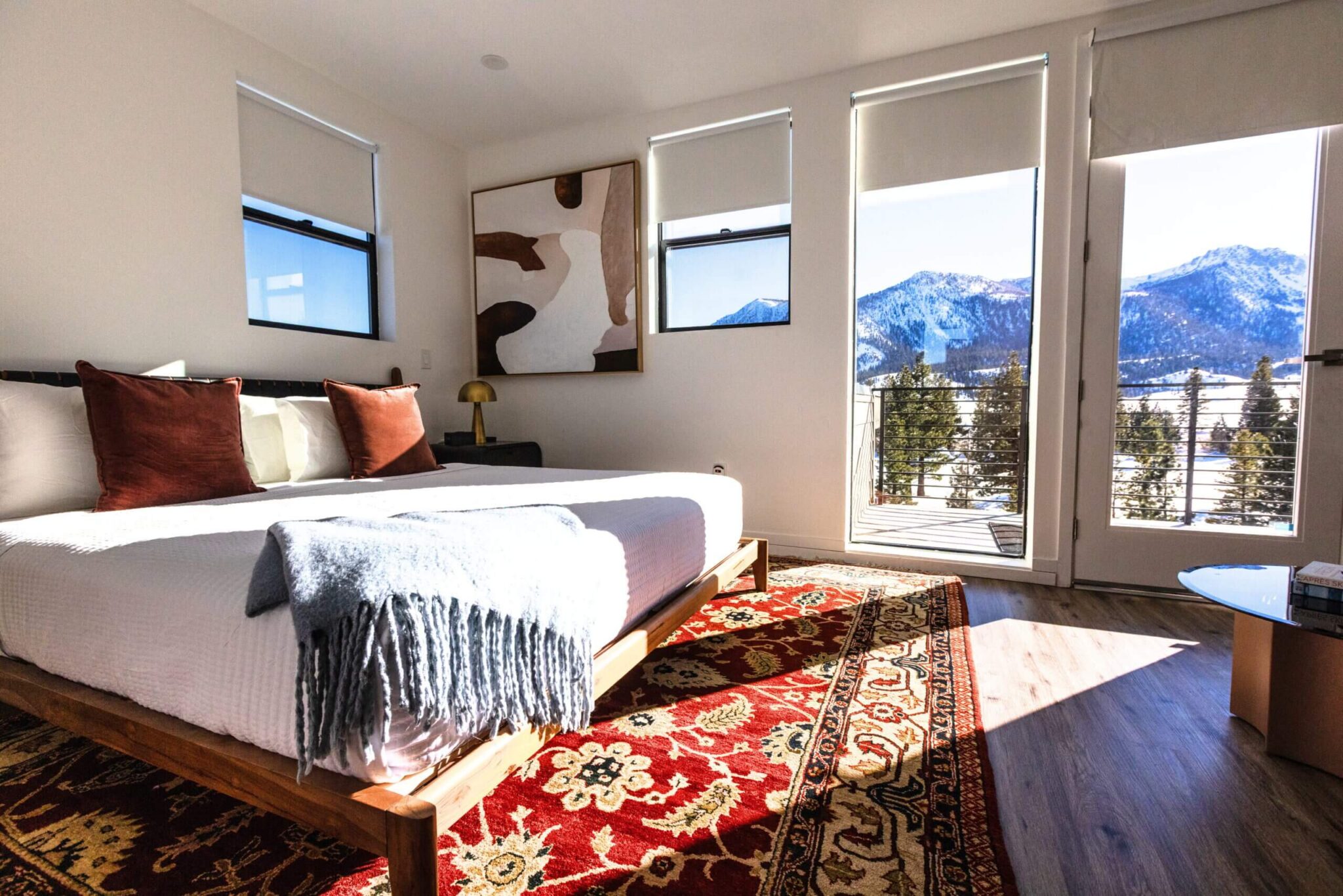 Sierra House bedroom with balcony access and panoramic snowy mountain views